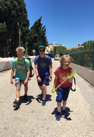 The boys leaning in during the final half mile of our walk to our beach apartment.