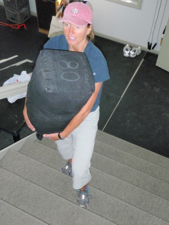 Having fun during a personal training session. Or, carrying an 80-pound sandbag up and down the stairs.
